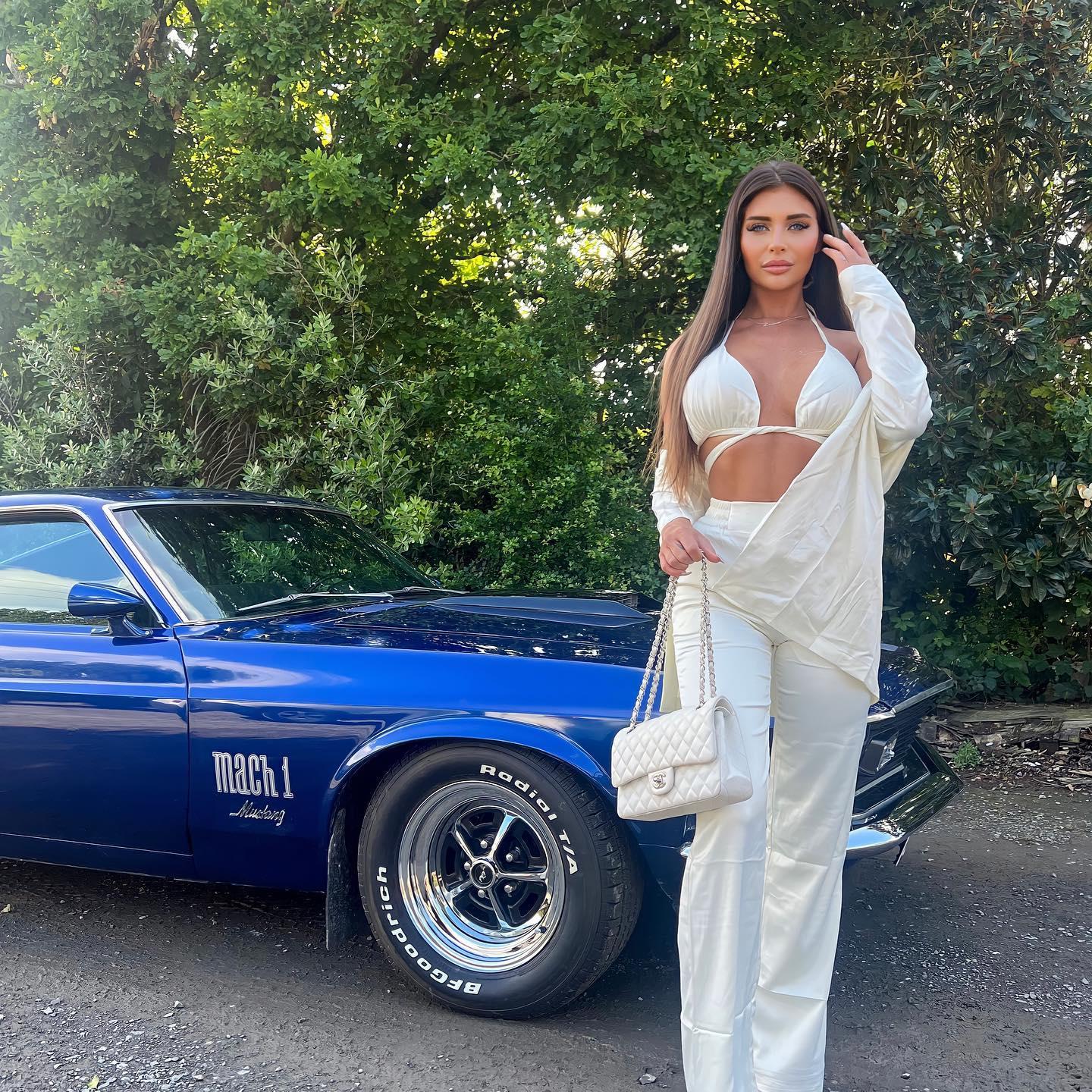 Larissa Trownson in a white bra top and slacks