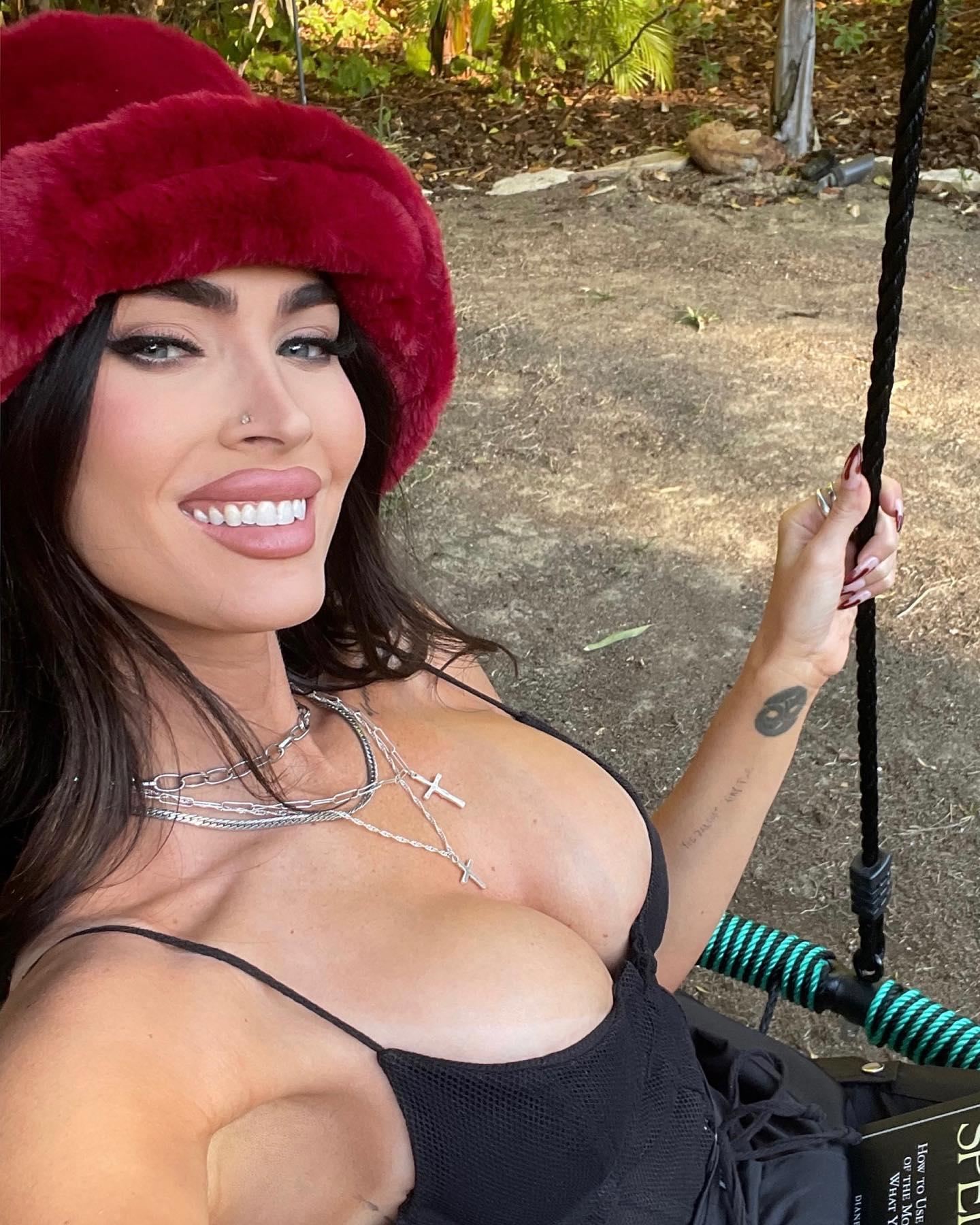 Megan Fox shares a selfie in a black top and red hat
