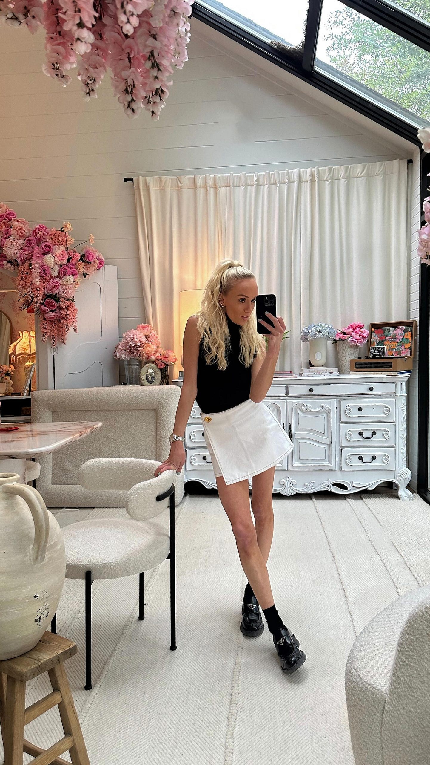 Nastia Liukin dresses in a black top and white skirt