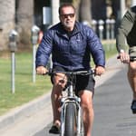 Arnold Schwarzenegger biking in Venice Beach after leaving GoldS Gym
