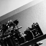 A black and white themed photo showing Halyna Hutchins with a huge camera set.