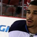 Evander Kane sits on the bench during an NHL game