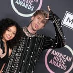 Machine Gun Kelly and daughter pose for the camera.