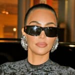 Kim Kardashian shows off her famous curves in a black dress