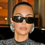 Kim Kardashian shows off her famous curves in a black dress