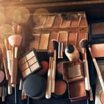 A collection of makeup brushes and palettes.