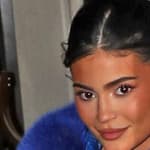 Kylie Jenner and daughter Stormi wow fans as they leave their hotel wearing an oversized blue crocodile skin and fur coat with a very leggy display