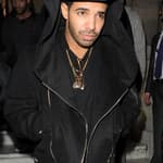 Drake leaving Aura nightclub The Canadian rapper wore a black hoodie grey jeans purple Timberland boots and a gold chain
