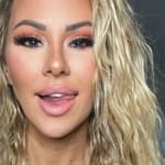 Kindly Myers shows off her new hair and a new outfit: a purple sports bra and gray CNC leggings