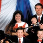 Jim Bob Dugger and his wife Michelle pose with there 13 children in this family photograph