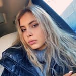 Andreea Dragoi taking a selfie inside the car.