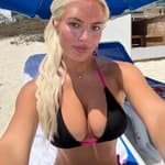 Hannah White taking a selfie at the beach in her bikini.