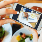 Taking picture of table of food