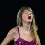 Taylor Swift holds a light saber style prop as bicycles and cars go by her in amazing visual show on stage during first weekend of her tour in Arizona