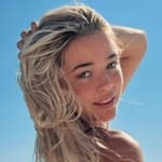 Olivia Dunne poses for the camera on a boat.