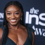 Simone Biles wearing an Aliette dress, Christian Louboutin shoes, and Matteo jewelry while carrying a Judith Leiber bag arrives at the 6th Annual InStyle Awards 2021