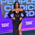 Porsha Williams posing in a black dress on the red carpet.