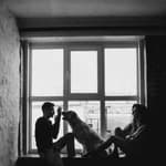 Man playing with dog and a lady