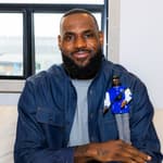LeBron James posing with his Ken Barbie doll.