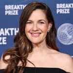 Drew Barrymore wearing Carolina Herrera, Alexis Bittar bag, and Swarovski jewelry arrives at the 11th Annual Breakthrough Prize Ceremony 2025
