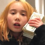 Lil Tay holding a lot of cash to her ear
