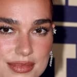 Dua Lipa smirking