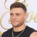 Gus Kenworthy posing on the red carpet.