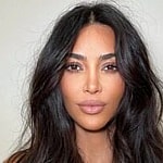 Kim Kardashian pursing her lips with messy hair