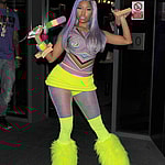 Nicki Minaj leaving the W Hotel in Leicester Square The singer showed off her new blue hair and wore a multicoloured top neon yellow hot pants tights and neon yellow boots