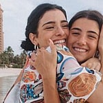 A lovely photo showing Dixie D'Amelio and Charli D'Amelio hugging on the beach.