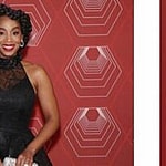 A photo showing Anika Noni Rose in a black ball dress at an event.