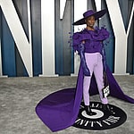 Billy Porter wearing massive purple hat