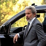 A photo showing Mark Harmon and his colleague standing by a vehicle.