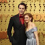 Sacha Baron Cohen and Isla Fisher smiling.