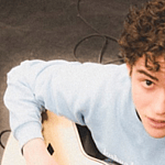 Joshua Bassett holding a guitar