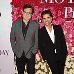 Bob Saget and John Stamos smiling.