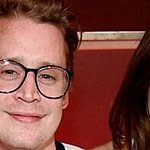 Macaulay Culkin and Brenda Song smiling.