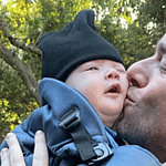 John Mulaney kissing his son