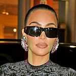 Kim Kardashian shows off her famous curves in a black dress