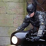Robert Pattinson's stunt double dressed as Batman rides a motorbike in Liverpool.