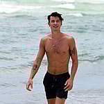 Shirtless Shawn Mendes looks happy as he has fun on the beach on his birthday in Miami