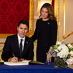 Prime Minister of Canada Justin Trudeau and his wife Sophe Trudeau sign a book of condolence at Lancaster House in London following the death of Queen Elizabeth II