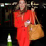 Olivia Wilde is all smiles while wearing a Red Suit as arriving to her hotel in New York City