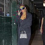 Kim Kardashian throws a peace sign as checking out her hotel in New York City