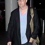 Matthew Perry shows off a fuller figure and double chin as he arrives at LAX airport