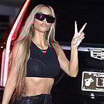 Kim Kardashian gives the peace sign as she heads out to a party with Khloe Kardashian and Jonathan Cheban in Miami