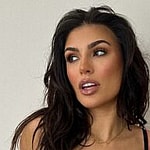 Emily Faye Miller poses in floral black lingerie