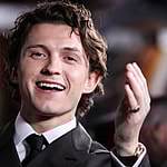 Tom Holland nearly bopped himself waving the chequered flag