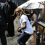 Rapper Lil Wayne sports yellow dreadlocks as he arrives to the wedding of rapper 2 Chainz