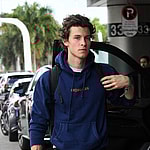 Singer Shawn mendes wraps up his Miami vacation as he is seen wearing a blue hoodie and black jeans at the Miami International Airport